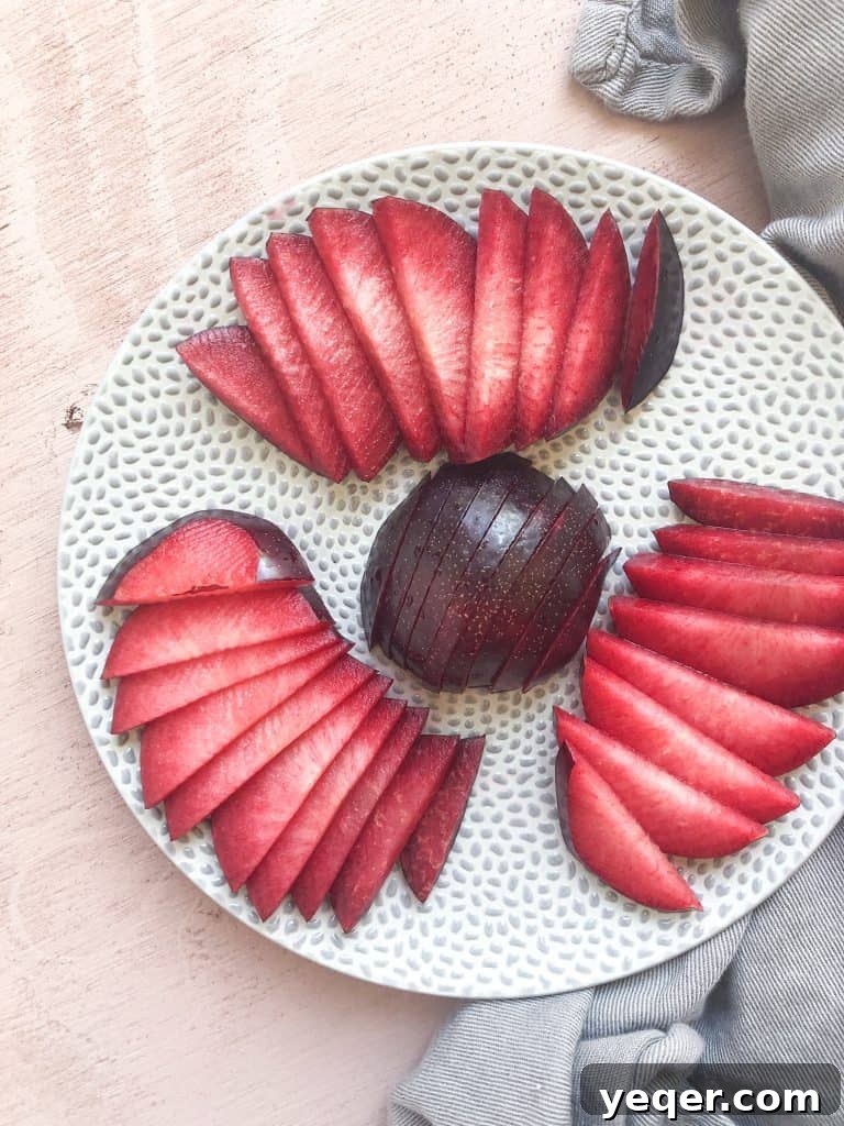 Ruby Plum Prosecco Sparkle 4 Freshly sliced plums on a plate.