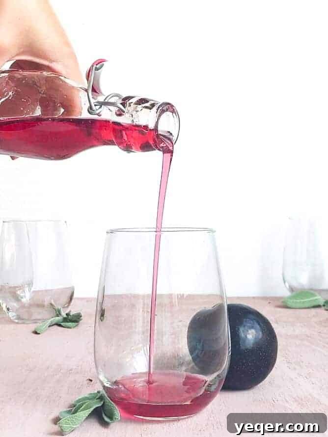 Ruby Plum Prosecco Sparkle 5 Plum syrup pouring into a glass.