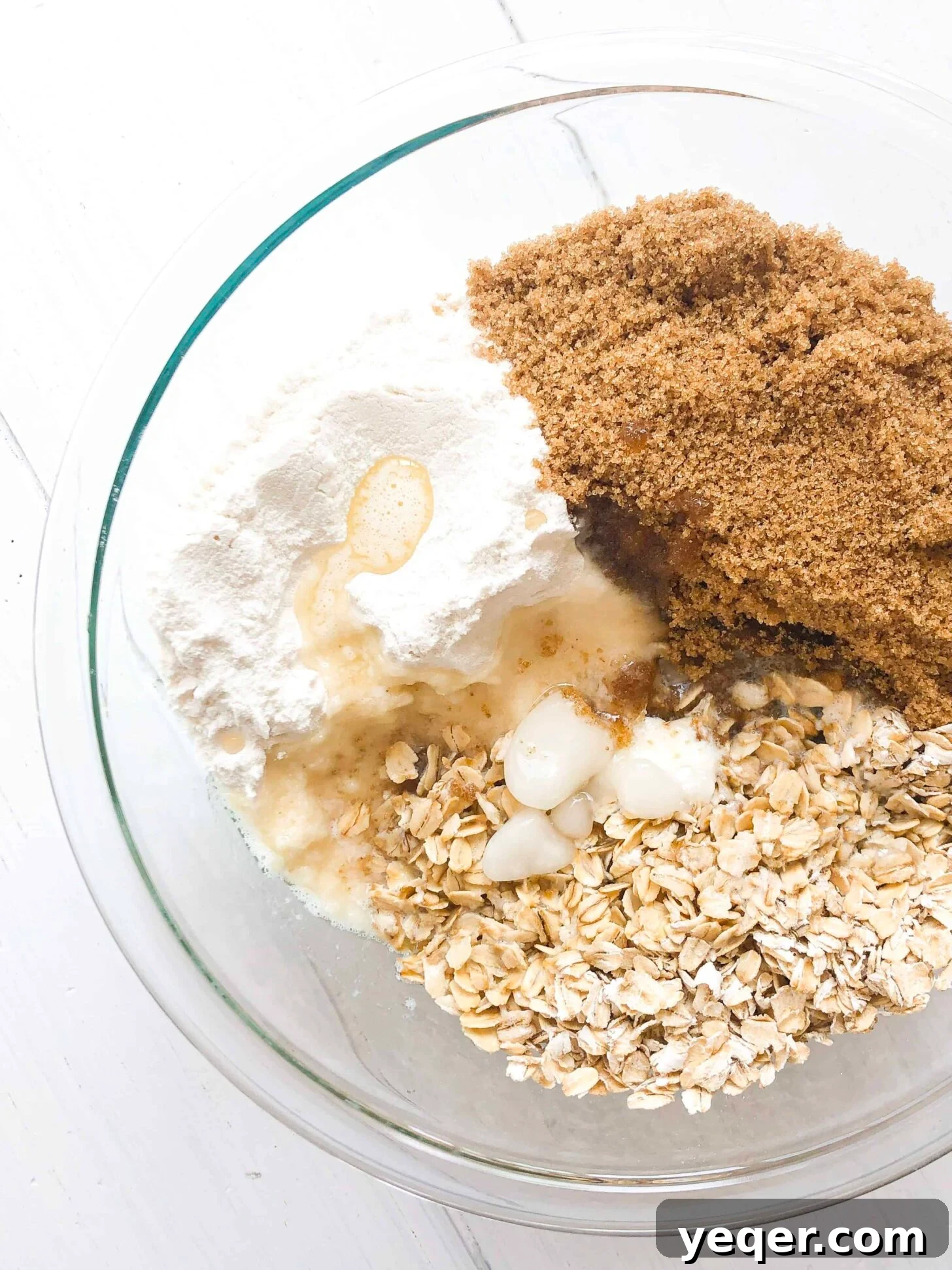 Heavenly Gluten Free Berry Crumble 4 A large mixing bowl containing a dry mixture of gluten-free flour, oats, brown sugar, and a stick of butter, ready to be combined for the crisp topping.