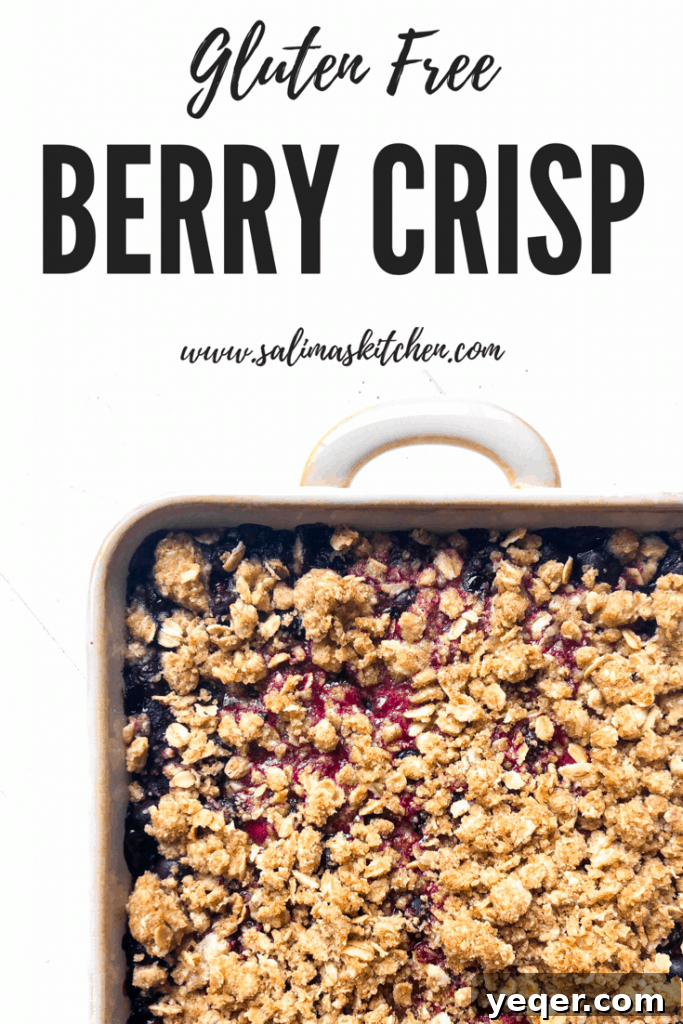 Heavenly Gluten Free Berry Crumble 7 A beautifully presented gluten-free berry crisp in a white baking dish, featuring a rich, golden, and crunchy oat topping with vibrant fruit bubbling underneath, perfect for pinning.