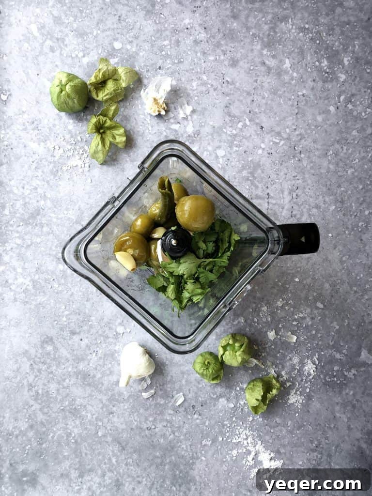 Smoky Tomatillo Salsa 6 A high-angle shot of the vibrant green salsa verde being blended in a food processor, highlighting its smooth, creamy texture before being served.