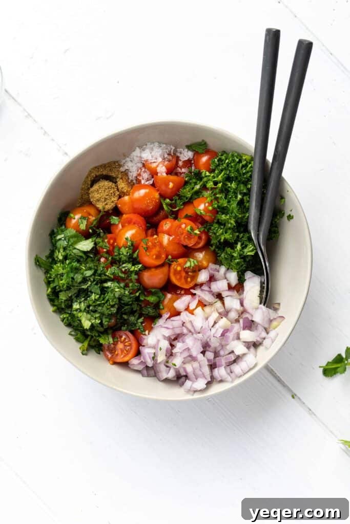 Vibrant Moroccan Tomato Salad 8 A vibrant bowl of classic Moroccan Tomato Salad, showcasing a mix of tomatoes, onion, and fresh herbs, garnished for serving.