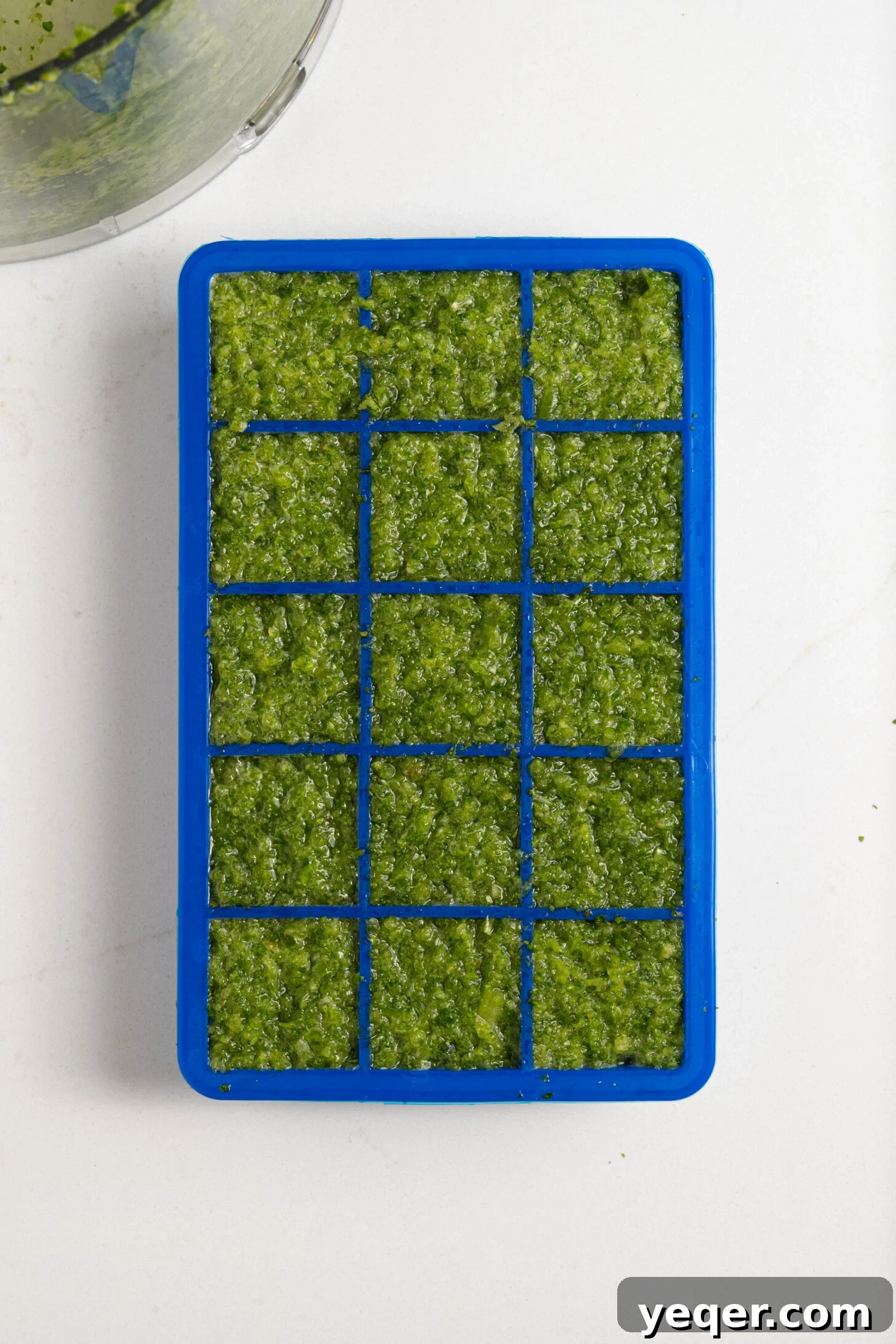 Vibrant Homemade Puerto Rican Sofrito 8 Sofrito frozen in an ice cube tray, showing individual portions.
