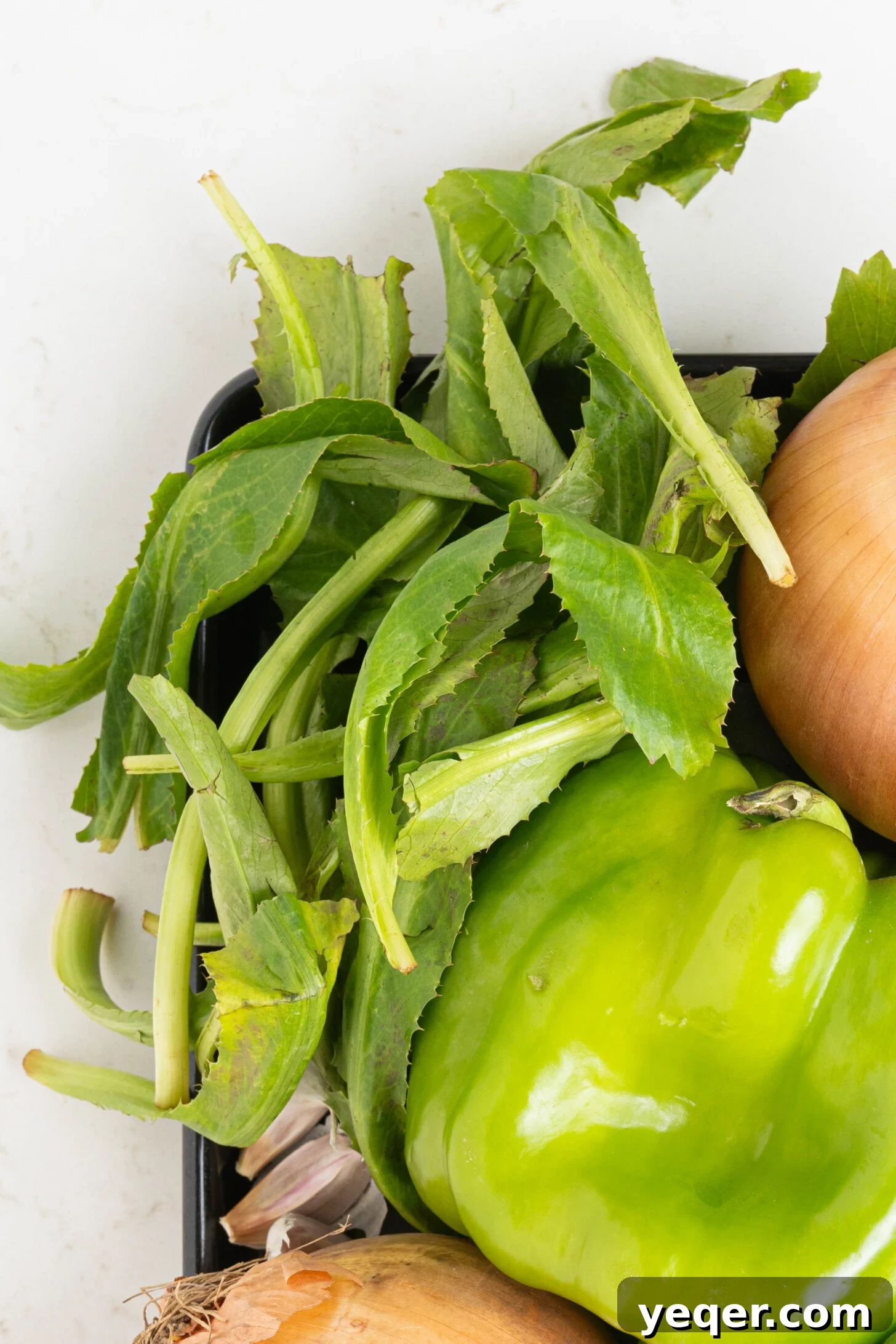 Vibrant Homemade Puerto Rican Sofrito 4 A platter with vibrant green culantro leaves, showing their distinct serrated edges.