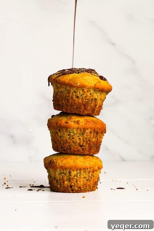Decadent Chocolate-Swirled Banana Oat Muffins 6 A stack of gluten-free banana oat muffins on a rustic background.