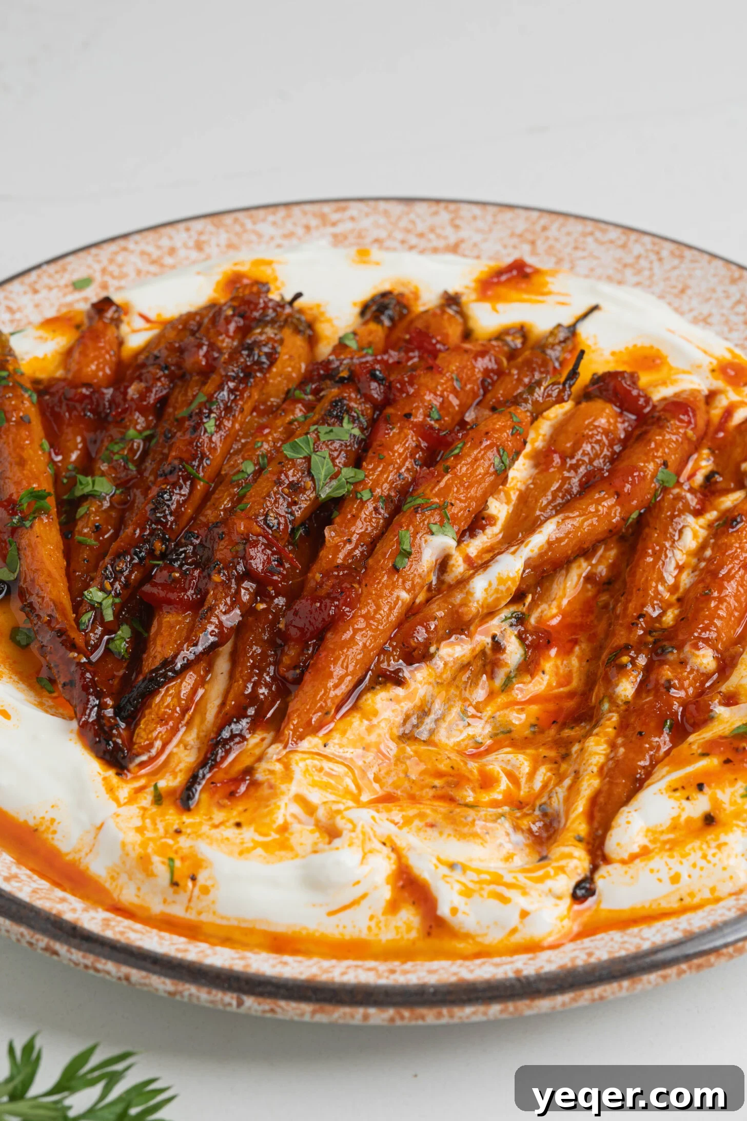 Harissa-Honey Roasted Carrots, Creamy Garlic Yogurt 9 Harissa honey roasted carrots on a plate.