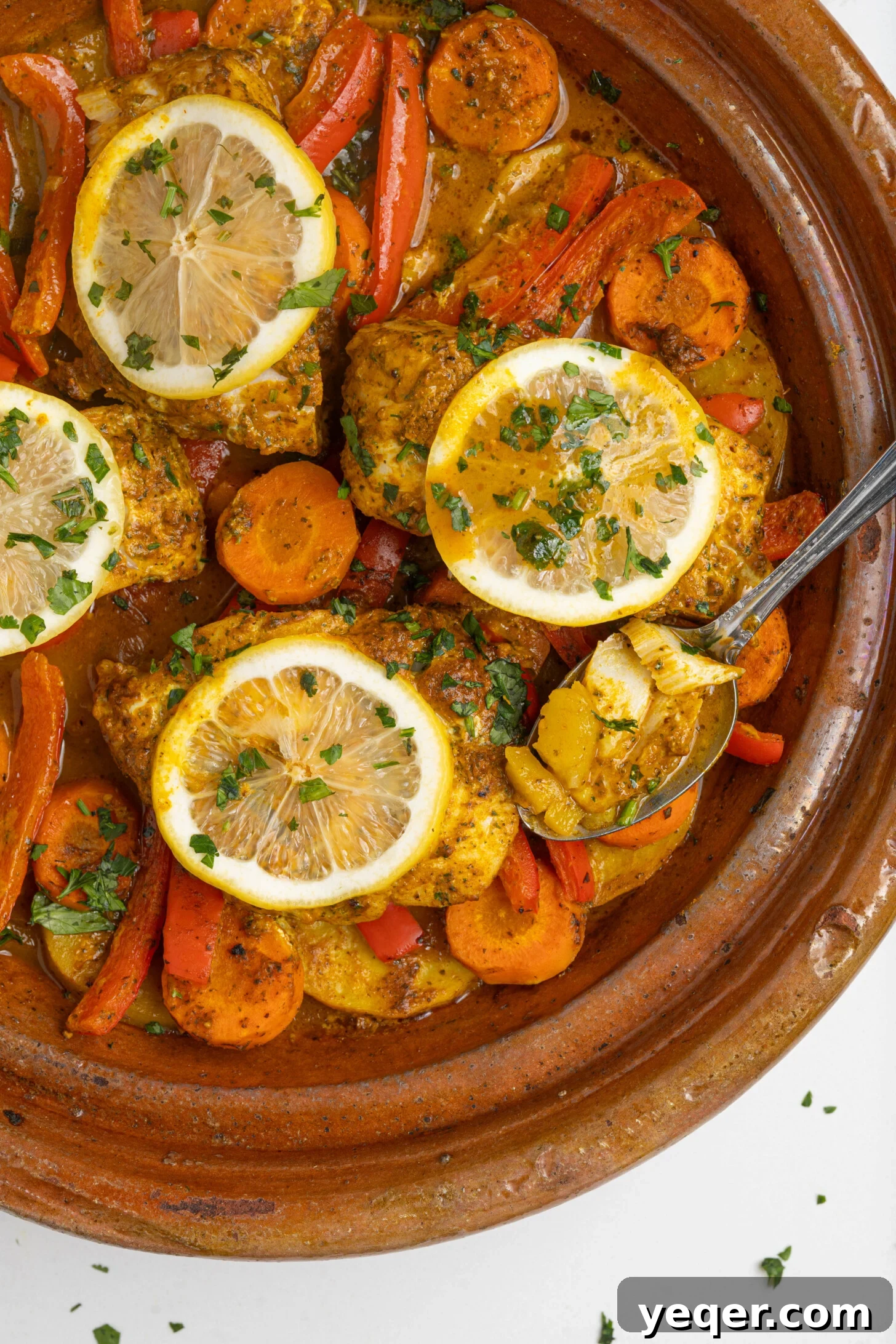 Moroccan Fish and Potato Tagine 2 A beautifully presented pot of Moroccan fish stew, brimming with fresh ingredients and vibrant colors, ready to be served.