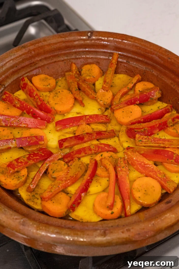 Moroccan Fish and Potato Tagine 5 A pot of vegetables stewing, covered with parchment paper and a lid, creating a moist cooking environment.