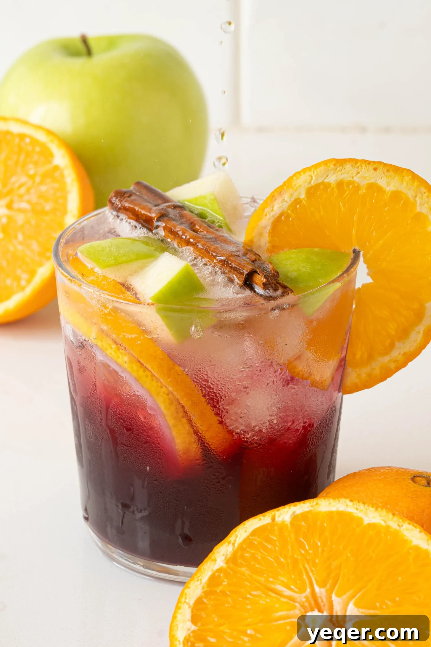 Authentic Spanish Red Sangria: Pitcher Perfect for Six 8 A close-up of a glass of red sangria with ice and fruit.