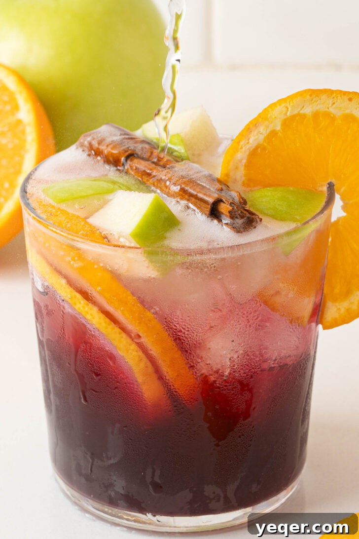 Authentic Spanish Red Sangria: Pitcher Perfect for Six 5 A refreshing glass of red sangria garnished with fruit slices.