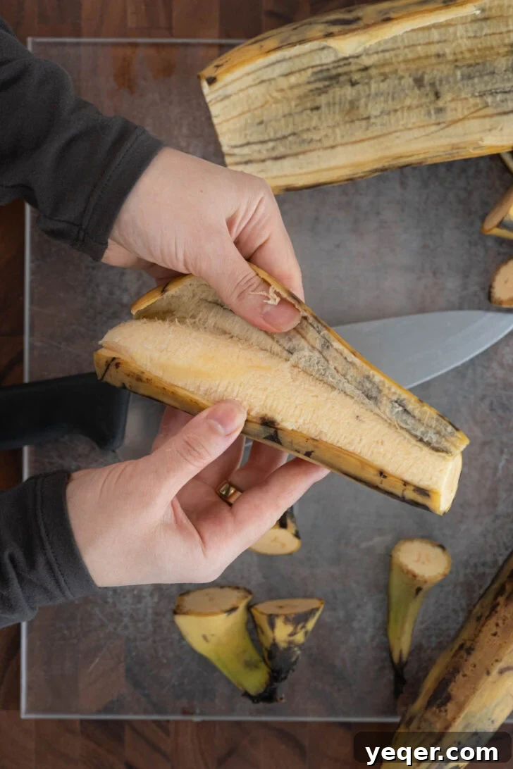 Puerto Rican Canoas Sweet Stuffed Plantain Delights 6 Hands carefully peeling a ripe brown plantain, revealing its golden flesh.