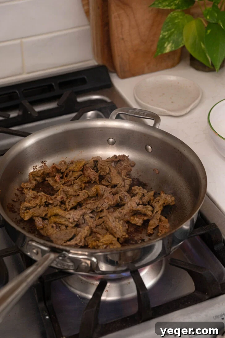 Tripleta: Puerto Rican Three-Meat Sandwich Recipe and Guide 3 Shaved steak being cooked.